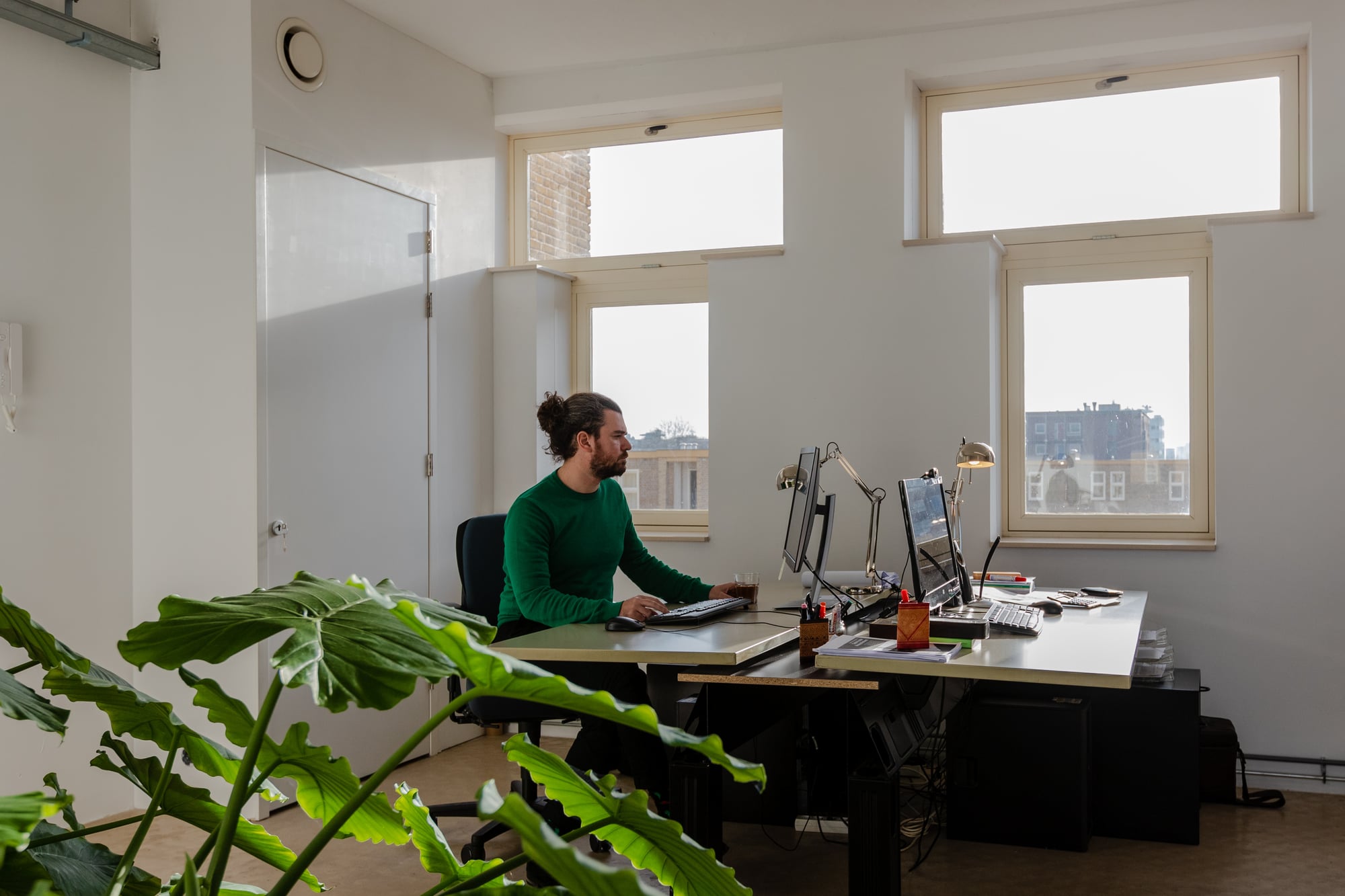Medewerker werkt aan bureau in kantoorruimte